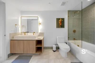 a bathroom with a sink and a toilet and a tub at Modern 1-BD Condo in Downtown Miami City Views in Miami
