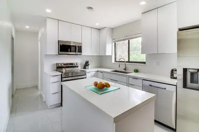 a kitchen with white cabinets and a white counter top at 5 Mi to Beach Group Getaway with Yard in Miami in Miami