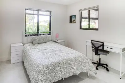 a bedroom with a bed and a desk and a chair at 5 Mi to Beach Group Getaway with Yard in Miami in Miami