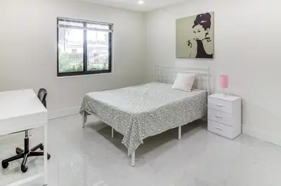 a white bedroom with a bed and a window at 5 Mi to Beach Group Getaway with Yard in Miami in Miami