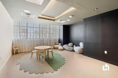 a room with a table and chairs and a window at Stylish Sky-High Condo with Pool and Gym in Miami