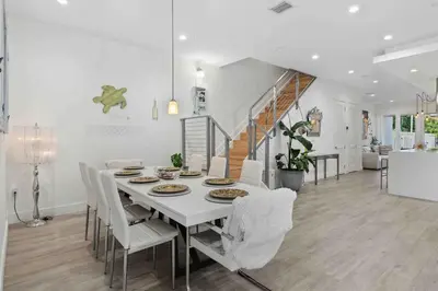 a white dining room with a white table and chairs at Modern Haven in Paradise w Heated Eco Pool 5B 4B in Miami