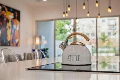 a kettle sitting on top of a kitchen counter at Modern Haven in Paradise w Heated Eco Pool 5B 4B in Miami