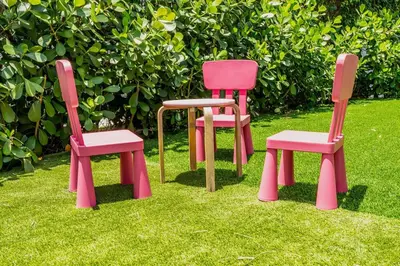 three different colored chairs sitting in the grass at TROPICAL Villa with POOL in Private Island in Miami Beach