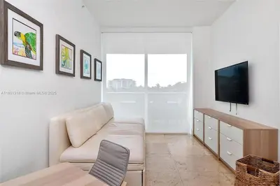 a living room with a couch and a tv at High-Rise Haven by the Sea in Sunny Isles Beach