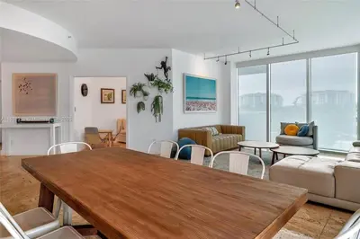 a living room with a wooden table and chairs at High-Rise Haven by the Sea in Sunny Isles Beach