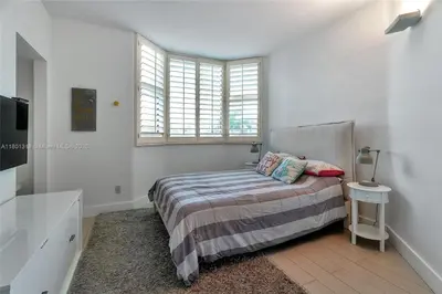 a bedroom with a bed and a window at High-Rise Haven by the Sea in Sunny Isles Beach