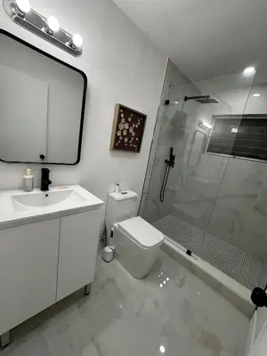 a bathroom with a toilet and a sink and a shower at Santuaria Hollywood in Hollywood