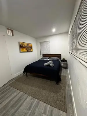 a bedroom with a bed with a blue blanket at Santuaria Hollywood in Hollywood