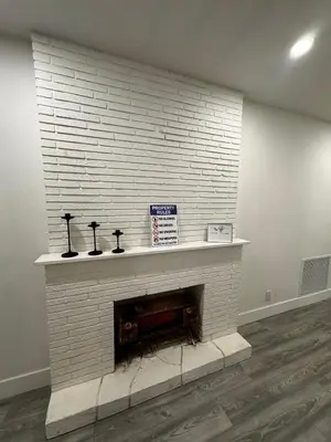 a white brick fireplace in a living room at Santuaria Hollywood in Hollywood
