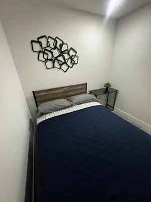 a bedroom with a bed with a blue comforter at Santuaria Hollywood in Hollywood