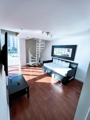 a bedroom with a bed and a table in a room at Shine Suites Duplex Bay7A in Miami Beach