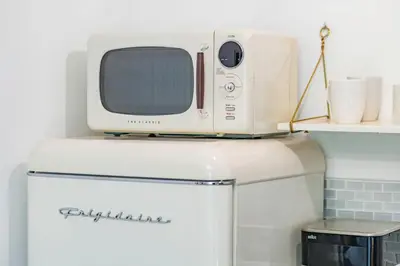 a microwave sitting on top of a refrigerator at Byron Avenue Suites in Miami Beach