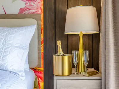 a lamp on a night stand next to a bed at Walk to Coral Gables| Beautiful Property| Sleeps 8 in Miami