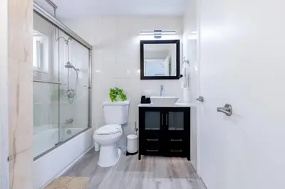 a bathroom with a toilet and a sink and a shower at Walk to Coral Gables| Beautiful Property| Sleeps 8 in Miami