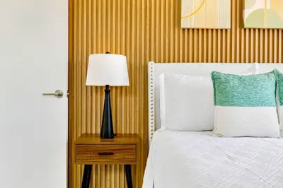 a bedroom with a bed and a lamp on a night stand at Prime Miami Retreat | Sleeps 12 | Parking, BBQ! in Miami