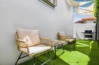 two chairs and a table on a patio with grass at Prime Miami Retreat | Sleeps 12 | Parking, BBQ! in Miami