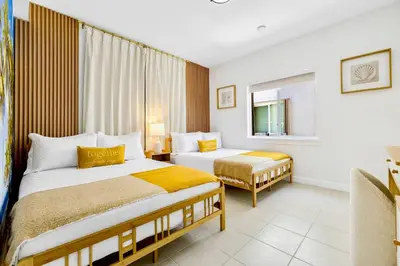 a hotel room with two beds and a window at Tropical | 8PPL | Top Location | Parking | Laundry in Miami