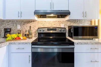 a kitchen with a stove and a microwave at Marina | Top Location | 8PPL | Parking | Laundry in Miami