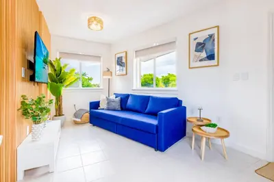a living room with a blue couch and a table at Marina | Top Location | 8PPL | Parking | Laundry in Miami