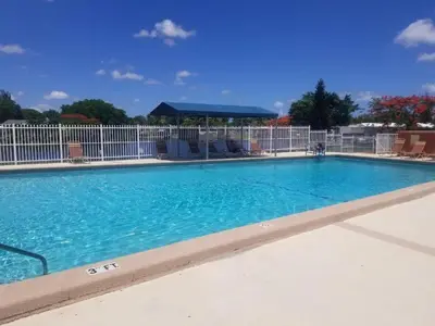 a swimming pool at a resort with blue water at 1161 Efficency Miami-Lakes in Tamiami