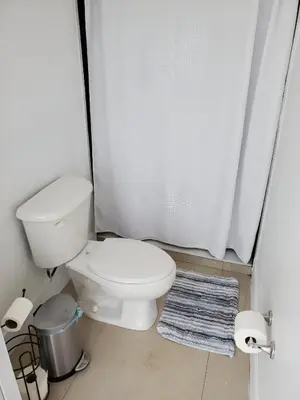 a bathroom with a toilet and a shower curtain at 1161 Efficency Miami-Lakes in Tamiami