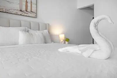 a bedroom with a bed with swan towels on it at 2 Bed Best Views in Downtown and Brickell in Miami