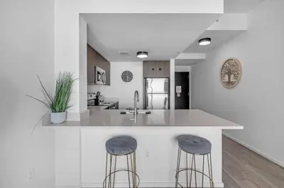 a kitchen with a large island with two bar stools at 2 Bed Best Views in Downtown and Brickell in Miami