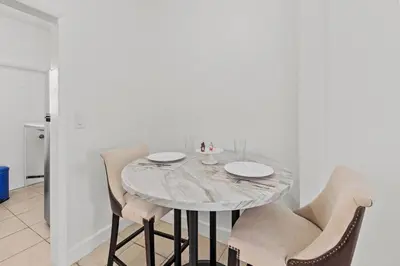 a dining room table with two chairs and a marble table at Stay in Brickell near Kaseya Center & South Beach in Miami