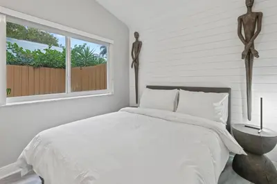 a white bedroom with a bed and a window at Charming Hideaway Near Beach, Nightlife & Shops in Fort Lauderdale