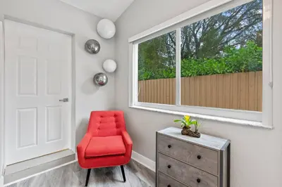 a red chair in a room with a window at Charming Hideaway Near Beach, Nightlife & Shops in Fort Lauderdale
