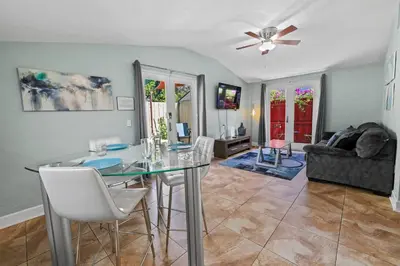a dining room with a glass table and chairs at Prime Location – Walkable to Wilton Drive in Fort Lauderdale