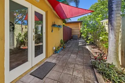 a walkway outside of a house with a red roof at Prime Location – Walkable to Wilton Drive in Fort Lauderdale