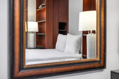 a reflection of a bed in a mirror at Cherry RoyaleGrand Villa in Davie