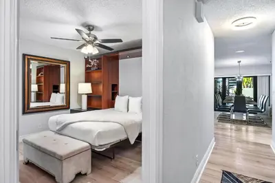 a bedroom with a bed and a ceiling fan at Cherry RoyaleGrand Villa in Davie