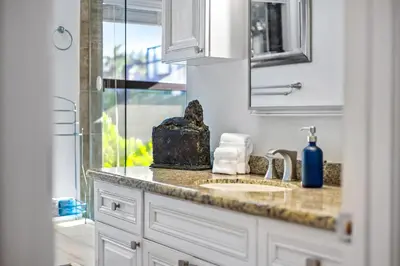 a bathroom counter with a sink and a mirror at Cherry RoyaleGrand Villa in Davie