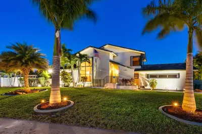 a house with palm trees in front of it at Cherry RoyaleGrand Villa in Davie