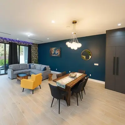 a living room with a table and a couch at Jungle Serene Lux Home with Pool Sauna Ice Bath in Fort Lauderdale