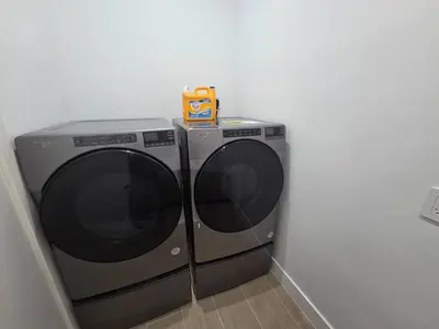 two washing machines sitting next to each other in a room at Jungle Serene Lux Home with Pool Sauna Ice Bath in Fort Lauderdale