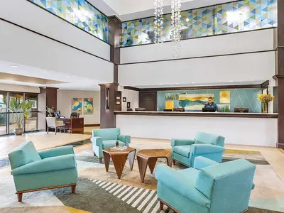 a lobby with blue chairs and a reception desk at Marriott's Villas at Doral 2BR Apartment with Resort Access in Miami