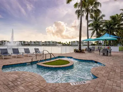 a swimming pool with a fountain and palm trees at Marriott's Villas at Doral 2BR Apartment with Resort Access in Miami