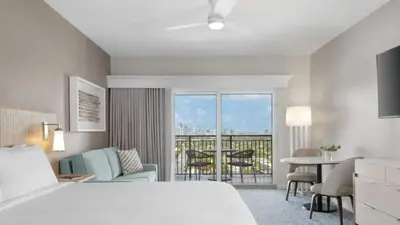 a hotel room with a bed and a table and chairs at Marriott's BeachPlace Towers Studio Apartment with Resort Access in Fort Lauderdale