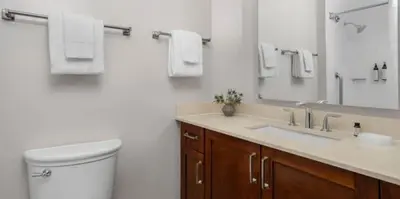 a bathroom with a toilet and a sink and a mirror at Marriott's BeachPlace Towers Studio Apartment with Resort Access in Fort Lauderdale