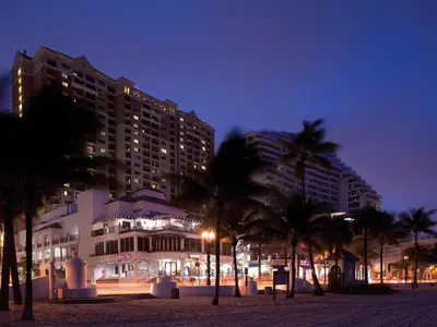 a large building with palm trees in front of it at Marriott's BeachPlace Towers Studio Apartment with Resort Access in Fort Lauderdale
