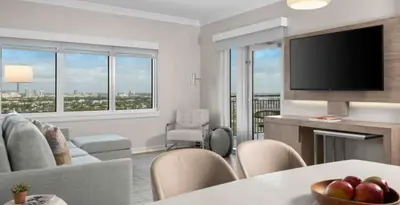 a living room with a couch and a table with a television at Marriott's BeachPlace Towers 1BR Apartment with Resort Access in Fort Lauderdale