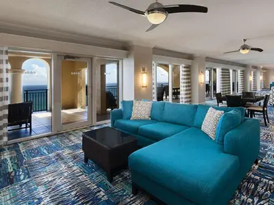 a living room with a blue couch and a table at Marriott's BeachPlace Towers 2BR Apartment with Resort Access in Fort Lauderdale
