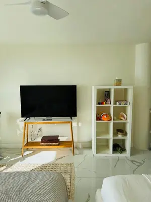 a living room with a flat screen tv on a wall at Beautiful Studio w Amazing View of Miami Skyline in Miami Beach