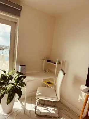a desk and a chair in a room with a window at Beautiful Studio w Amazing View of Miami Skyline in Miami Beach