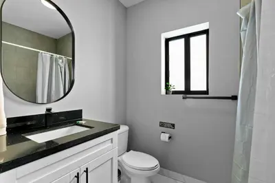 a white bathroom with a sink and a mirror at Family-Friendly Apt in Miami - Sleeps 4, Near Everything in Miami