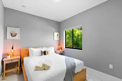 a bedroom with a large white bed with a window at Urban Comfort - 20min to Beach & Airport in Miami
